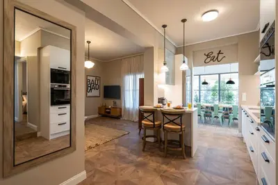 a kitchen with a table and a mirror at Luxury Petralona Penthouse - Sleeps 7 -Near Metro in Athens