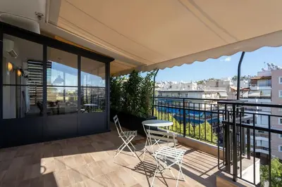 a balcony with a table and chairs and a view at Luxury Petralona Penthouse - Sleeps 7 -Near Metro in Athens