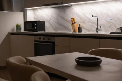 a kitchen with a table with chairs and a sink at Cozy & Chic Stay with Patio Near Metro Station in Athens