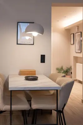 a dining room with a table and chairs at Cozy & Chic Stay with Patio Near Metro Station in Athens