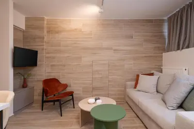 a living room with a couch and a table at Cozy & Chic Stay with Patio Near Metro Station in Athens