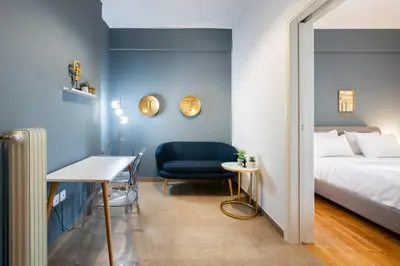 a bedroom with a bed and a blue wall at Chic One-Bedroom retreat near Panathenaic Stadium in Athens