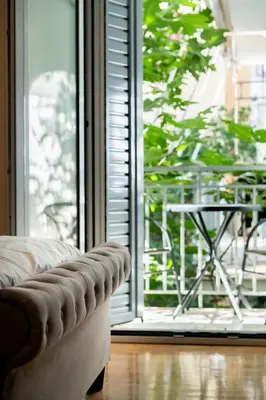 a couch sitting in front of a large window at Chic One-Bedroom retreat near Panathenaic Stadium in Athens
