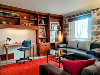 a living room with a couch and a table at Charming Stone house, 500 meters to Acropolis in Athens