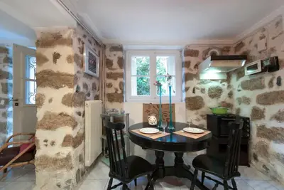 a kitchen with a table and chairs in a room at Charming Stone house, 500 meters to Acropolis in Athens