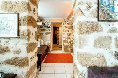 a hallway of a house with a stone wall at Charming Stone house, 500 meters to Acropolis in Athens