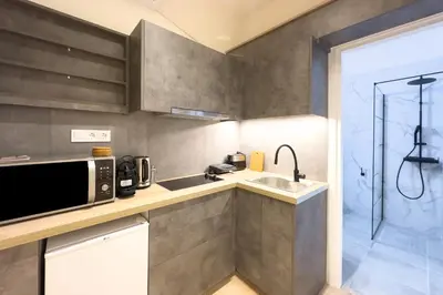 a kitchen with a microwave and a sink at White Luxe Suite in Kolonaki in Athens