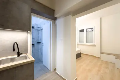 a bathroom with a sink and a shower at White Luxe Suite in Kolonaki in Athens