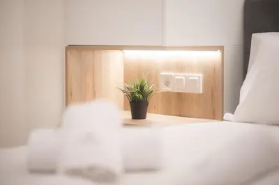 a potted plant sitting on top of a bed at White Luxe Suite in Kolonaki in Athens
