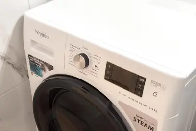a white washing machine in a white room at White Luxe Suite in Kolonaki in Athens