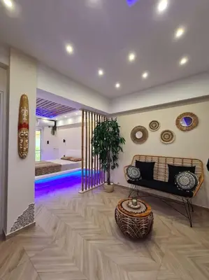 a living room with a couch and a table at Boho 3siblings in Athens