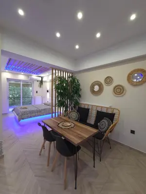 a living room with a wooden table and chairs at Boho 3siblings in Athens