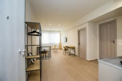 a living room with a ladder and a dining room at Stoa Luxury Apartment in Athens