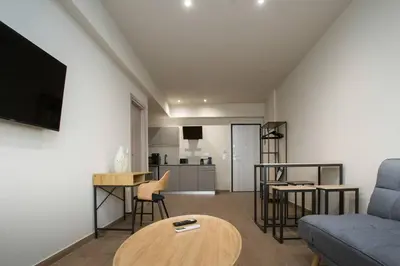 a living room with a couch and a table at Stoa Luxury Apartment in Athens