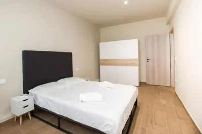 a bedroom with a large white bed in a room at Stoa Luxury Apartment in Athens