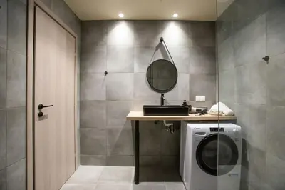 a bathroom with a washing machine and a mirror at Stoa Luxury Apartment in Athens
