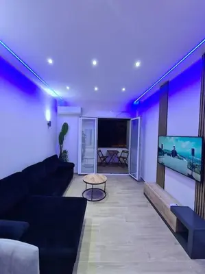 a living room with a couch and a flat screen tv at Luxury 3siblings in Athens