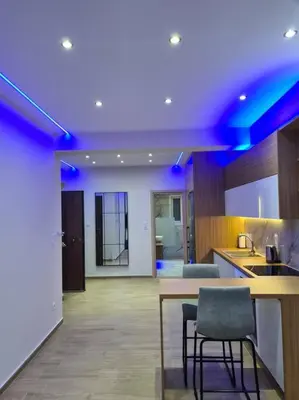 a kitchen with blue lights on the ceiling at Luxury 3siblings in Athens