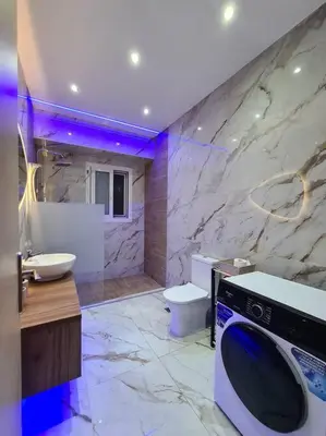 a bathroom with a sink and a washing machine at Luxury 3siblings in Athens