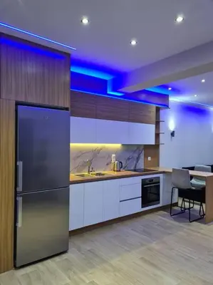 a kitchen with a refrigerator and a table in it at Luxury 3siblings in Athens