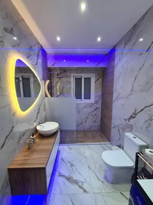 a bathroom with a toilet and a sink and a mirror at Luxury 3siblings in Athens