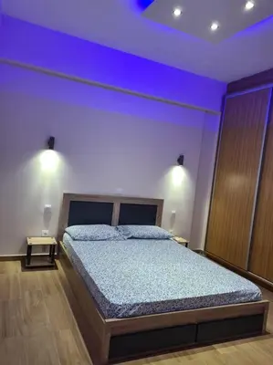 a bedroom with a large bed with blue lighting at Luxury 3siblings in Athens