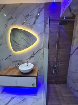 a bathroom with a sink and a shower with a mirror at Luxury 3siblings in Athens