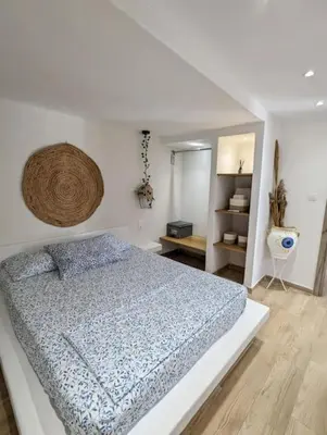 a bedroom with a bed with a blue comforter at MatchBox 3siblings in Athens