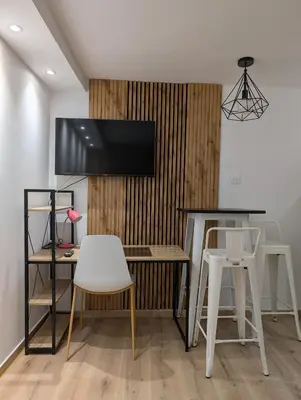 a kitchen with a table and two white stools at MatchBox 3siblings in Athens