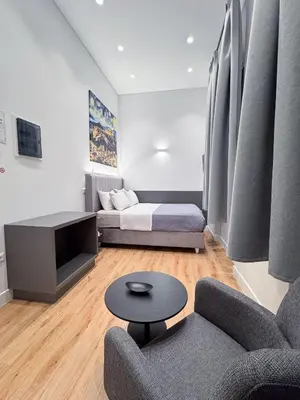 a living room with a couch and a table at Athinaidos rooms Prime location in Athens