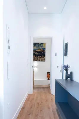 a living room with white walls and a blue table at Athinaidos rooms Prime location in Athens