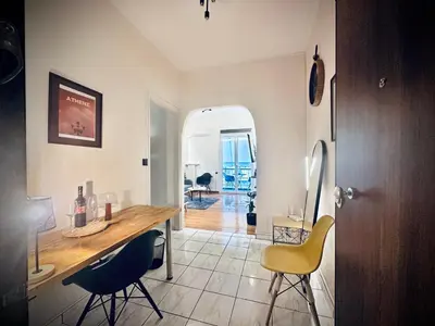 a kitchen with a table and chairs in a room at St Tomas Square Apartment in Athens