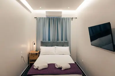 a small bedroom with a bed with towels on it at athens guest in Athens