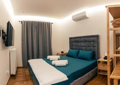 a bedroom with a blue bed with towels on it at athens guest in Athens