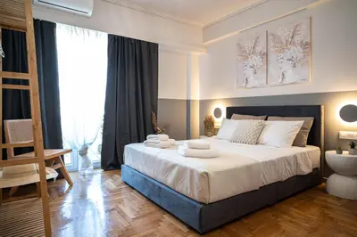 a bedroom with a large bed with towels on it at Athens Horizon Suite by GK Properties in Athens