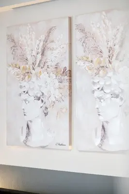 two framed drawings of two women with flowers on their heads at Athens Horizon Suite by GK Properties in Athens
