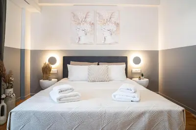 a bedroom with a bed with towels on it at Athens Horizon Suite by GK Properties in Athens