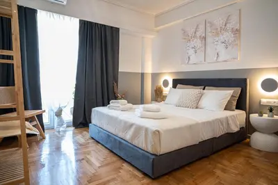 a bedroom with a large bed with towels on it at Athens Horizon Suite by GK Properties in Athens