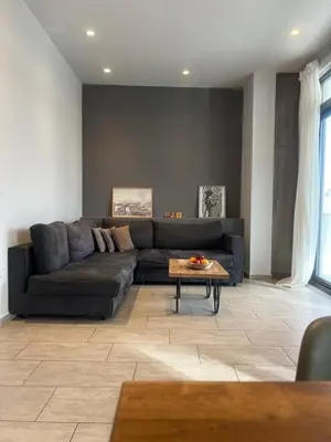 a living room with a couch and a table at Penthouse with Terrace and Acropolis View - Themelio Suites in Athens