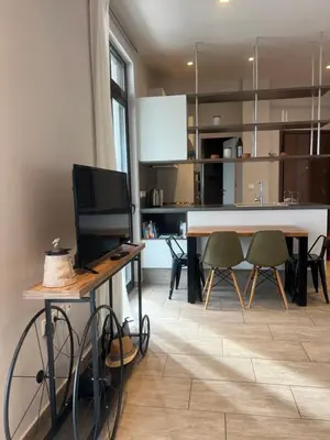 a kitchen and dining room with a table and chairs at Penthouse with Terrace and Acropolis View - Themelio Suites in Athens