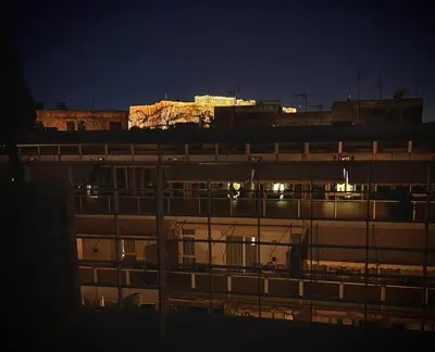 a night view of a building with lights on at Penthouse with Terrace and Acropolis View - Themelio Suites in Athens