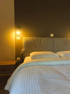 a bedroom with a large bed with white pillows at Penthouse with Terrace and Acropolis View - Themelio Suites in Athens