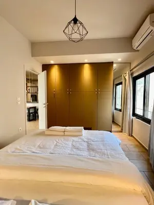 a bedroom with a large bed in a room at Penthouse with Terrace and Acropolis View - Themelio Suites in Athens