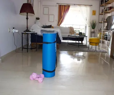 a bedroom with a bed and a blue pillar in the floor at Welcome to Elena's Athens Suite! in Athens