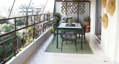a balcony with a table and chairs on it at Welcome to Elena's Athens Suite! in Athens