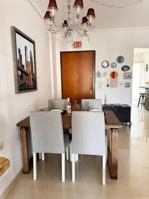 a dining room with a wooden table and chairs at Welcome to Elena's Athens Suite! in Athens