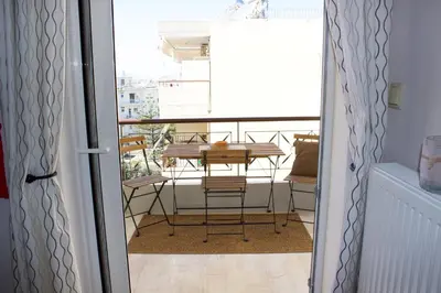 a balcony with a table and chairs in a room at Welcome to Elena's Athens Suite! in Athens