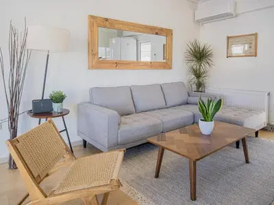 a living room with a couch and a table at Casa Acropolis - Stunning 3Br Apt with Private Terrace in Athens
