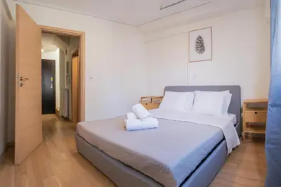 a bedroom with a large bed with white pillows at Casa Acropolis - Stunning 3Br Apt with Private Terrace in Athens
