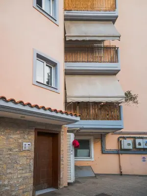 a building with a door and a balcony at Casa Acropolis - Stunning 3Br Apt with Private Terrace in Athens